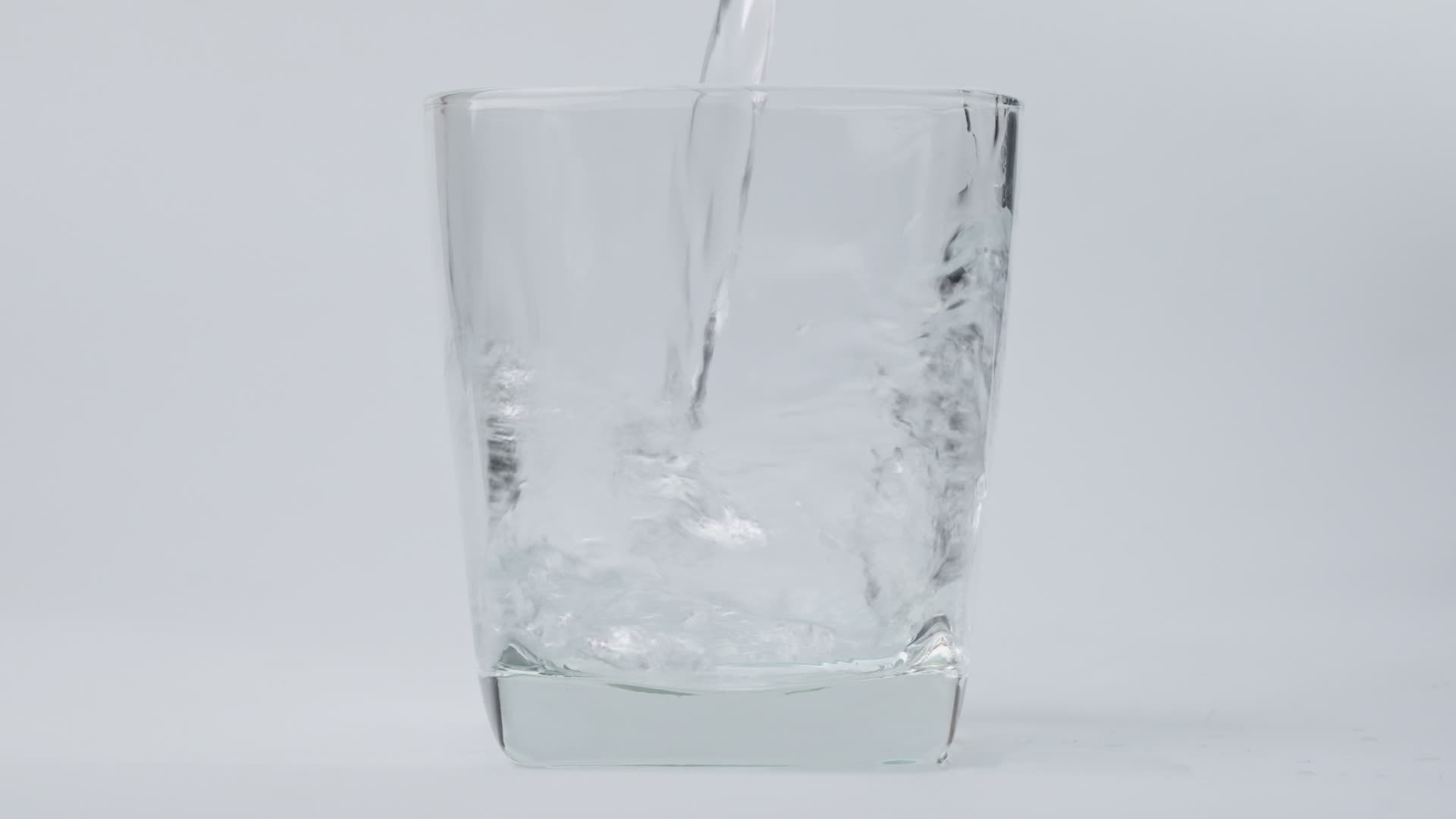 Pouring fresh pure drinking water into glass isolated on white