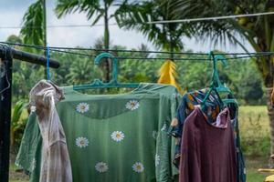 Clothes hangin in clothesline at sunny day photo