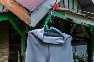 Clothes hanging in clothesline at sunny day photo