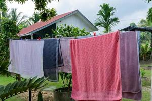 Clothes hangin in clothesline at sunny day photo