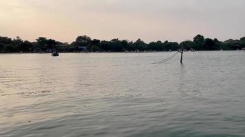 view of lake at the sunset with people. Thailand public park. video