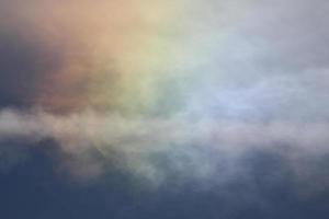 Iridescent clouds on a blue sky photo