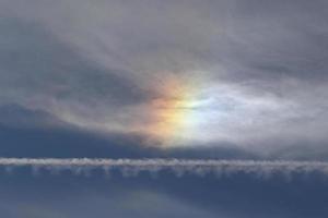 Iridescent clouds on a blue sky photo