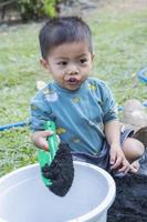 Little child shovels soil into pots to prepare plants for planting. Toddler boy digging soil for planting to Mother's little helper. Gardening. Hobbies at home horticulture. Leisure activities concept photo