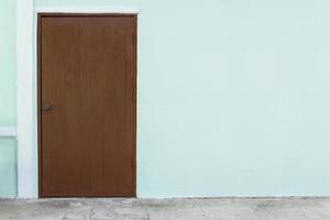 oak wood door in white concrete wall background photo