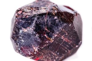 Macro of a mineral garnet stone on a white background photo