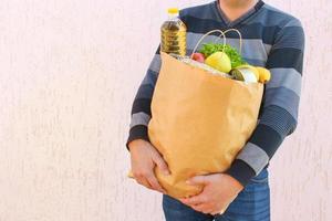 Cardboard bag with products. Concept of man engaged in charity. photo