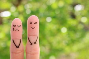 Fingers art of couple. Woman cries, man laughs. photo