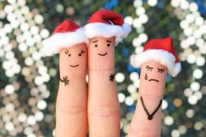 Fingers art of happy couple laughing in New Year hats. Woman is angry and jealous. Fingers art of couple celebrates Christmas. photo