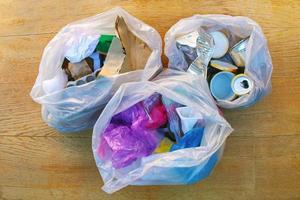 Garbage bag with different trash. Garbage sorting iron, paper, plastic. photo