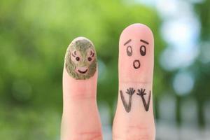 Fingers art of couple. Husband saw his wife with clay face mask and was afraid. photo