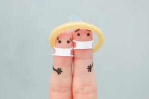 Fingers art of Happy couple in medical mask from COVID-2019. Concept of safe sex. photo