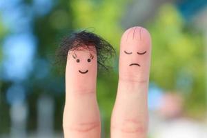 Fingers art of couple. This man is upset because he is bald. photo