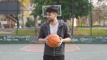 Man trying to play basketball to calm his anger. Anger control. The man trying to play basketball gets angry, throws the ball away and gets aggressive. video