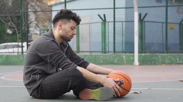 Unhappy young man sad and depressed. To be frustrated. Unhappy young man sitting alone outdoors and thinking. video