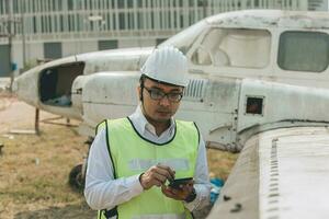 Aircraft mechanic examining airplane wing photo