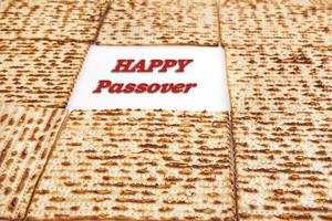 Pesach celebration concept - Jewish holiday Pesach. Frame from square matzah isolated on white background. Happy Passover inscription photo