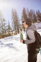 Young woman enjoing winter day of skiing fun in the snow photo