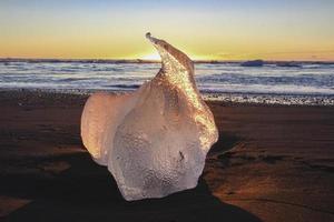 Ice on the beach at sunrise photo