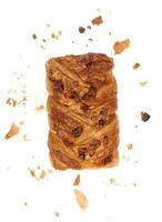 Rectangular pastry made from puff pastry with maple syrup and pecan nuts on a white background, surrounded by crumbs photo