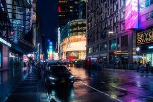 New York City, USA - August 9, 2019-People and tourists stroll among the lights and skyscrapers of Time Square in Manhattan during a summer night photo