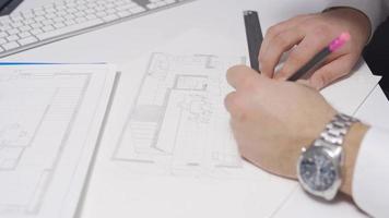 Interior designer is designing and drawing the kitchen of a house at his desk. Perspective drawing. The designer architect is designing the interior of a modern kitchen. Architectural touches. video