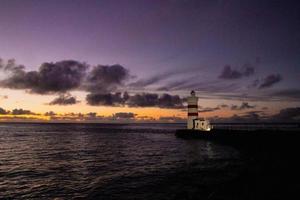 puesta de sol a el gardur antiguo faro en Islandia foto