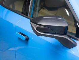 Side mirror of a  blue car close up. Exterior detail photo