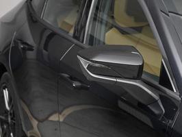 Side mirror of a  black car close up. Exterior detail photo