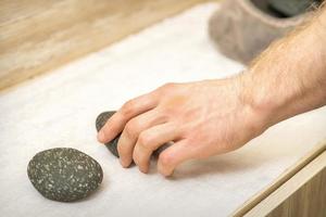 Masseur is taking massage stones photo