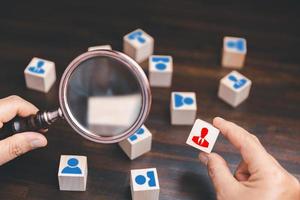 Manager chooses and hiring team for business success. HR manager hand or Employer chooses takes in hand employee. Leader stands out from crowd. Looking for good worker. HR, HRM, HRD concepts photo
