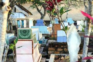 Historic place of public cemetery with natural floral background of buildings and trees photo