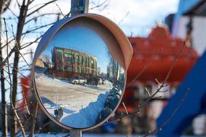 Convex mirror of spherical type on pole reflecting road photo