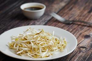 Bean sprouts of mung, maash. Traditional vegan dish in east Asia. Healthy diet food. photo