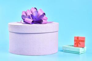 Round gift box with bow and two small gift boxes photo