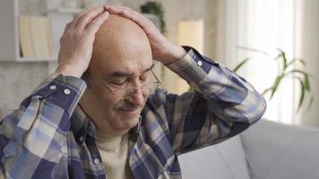 Dramatically depressed old man in pain and anger. Old man suffering from psychological distress, bored and overwhelmed at home alone. video