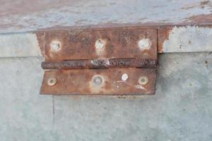 Rusty white metal gate with door hinge, close-up background photo