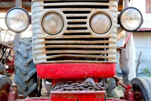 Red tractor. The concept of work in a fields and agriculture industry. photo