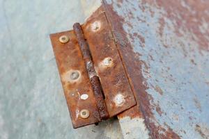 Rusty white metal gate with door hinge, close-up background photo