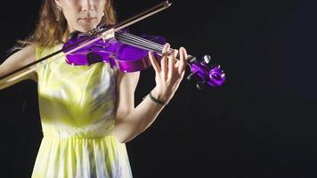 talentuoso femmina violinista giocando il violino nel il studio. musicista. femmina violinista giocando il violino nel il musica lirica o buio musica sala. classico musiche. video