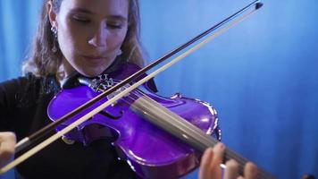 The female violinist plays the violin at the music school, the musician plays the violin at the opera. Woman playing violin in opera or dark music hall. Classical Musics. video