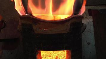 Stainless steel pots set on a clay stove fired by wood-fired charcoal, rural kitchens in Thailand often use this type of fuel instead of gas. video