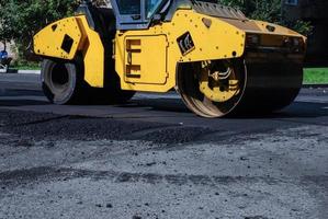 Road roller in residential area, asphalt road renovation works i photo