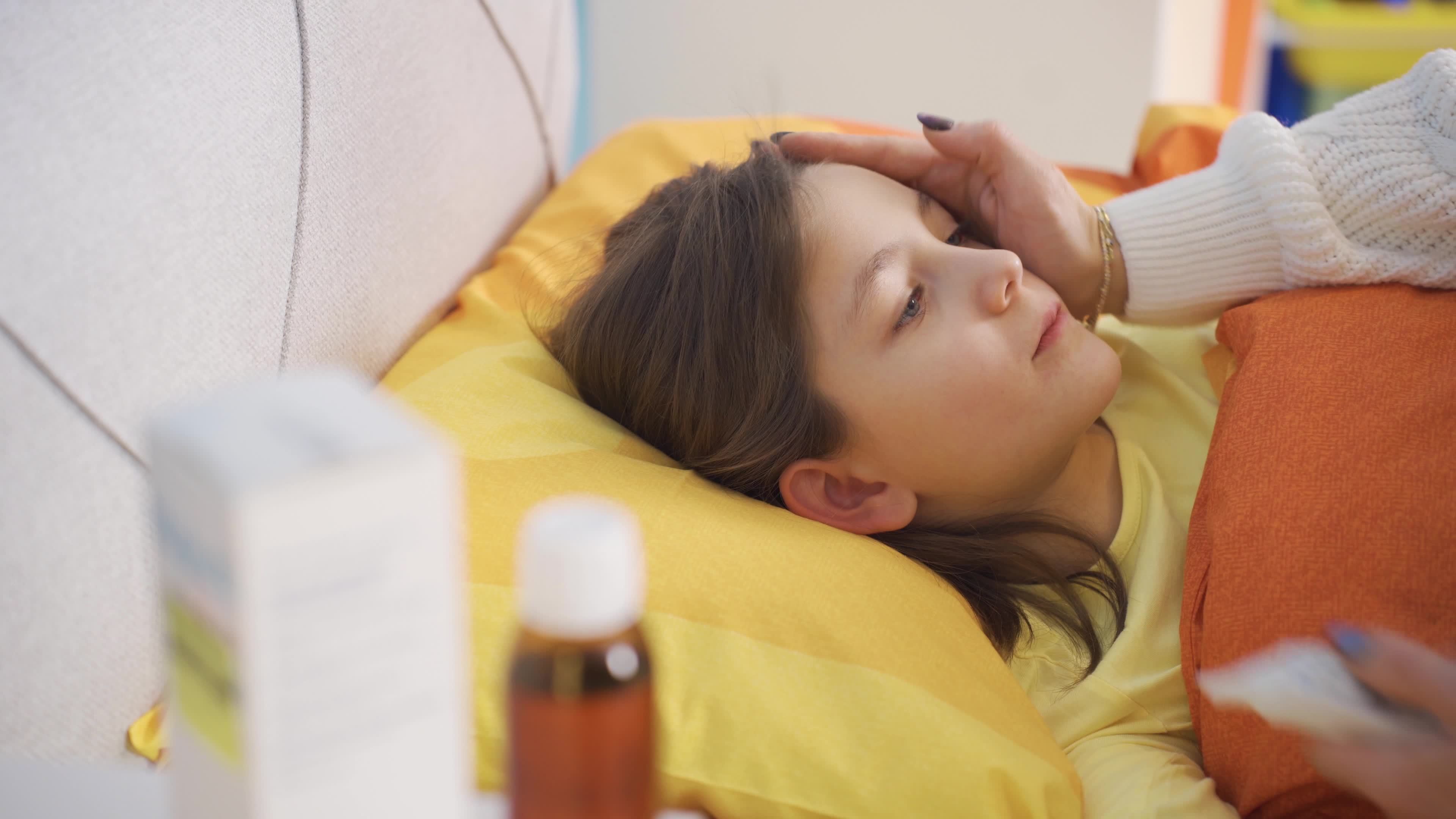The devoted mother taking the temperature of the sick little girl. Cute