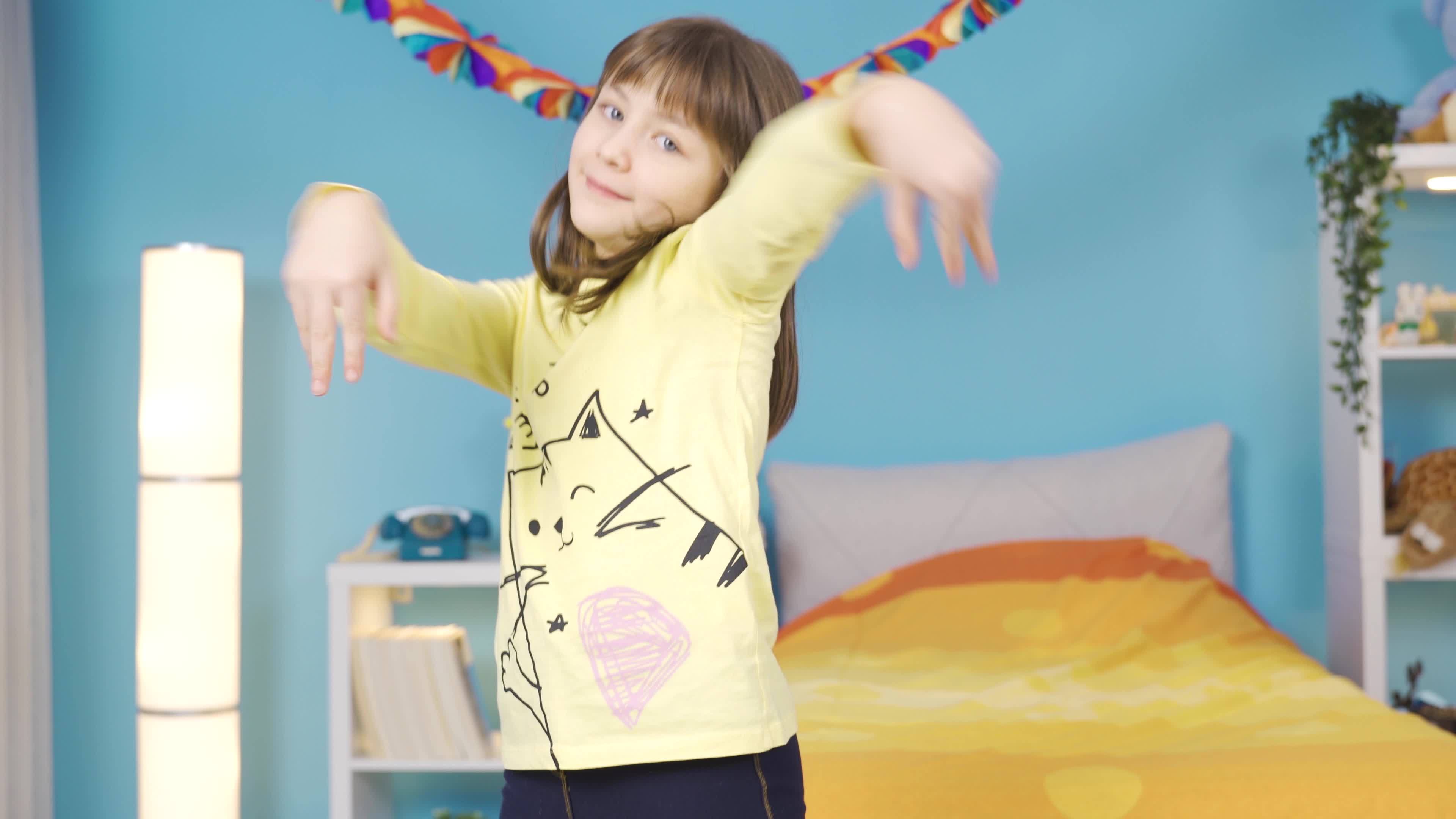 Dancer little girl performing dance show in her room at home. Cute