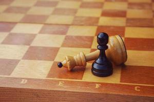 black pawn won chess game, weak opponent defeated superior forces photo