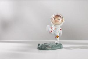 Man doll in space suit on a white table photo