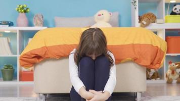 Beautiful little girl feeling unhappy alone in her room, depressed. Sad little girl feeling sad alone in room not feeling well. The concept of domestic violence, Child abuse concept. video