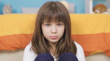 Beautiful little girl feeling unhappy alone in her room, depressed. Sad little girl feeling sad alone in room not feeling well. The concept of domestic violence, Child abuse concept. Boredom. video