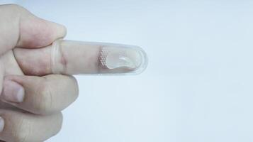 A hand wearing baby tooth brush or infant tooth brush, helping the first teeth clean isolated on white some negative space. photo